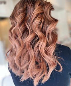 Brunette woman with dark blonde and rose gold balayage